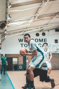 A basketball player catches a ball.