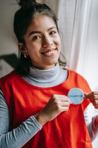A woman with a name badge identifying her as a volunteer.