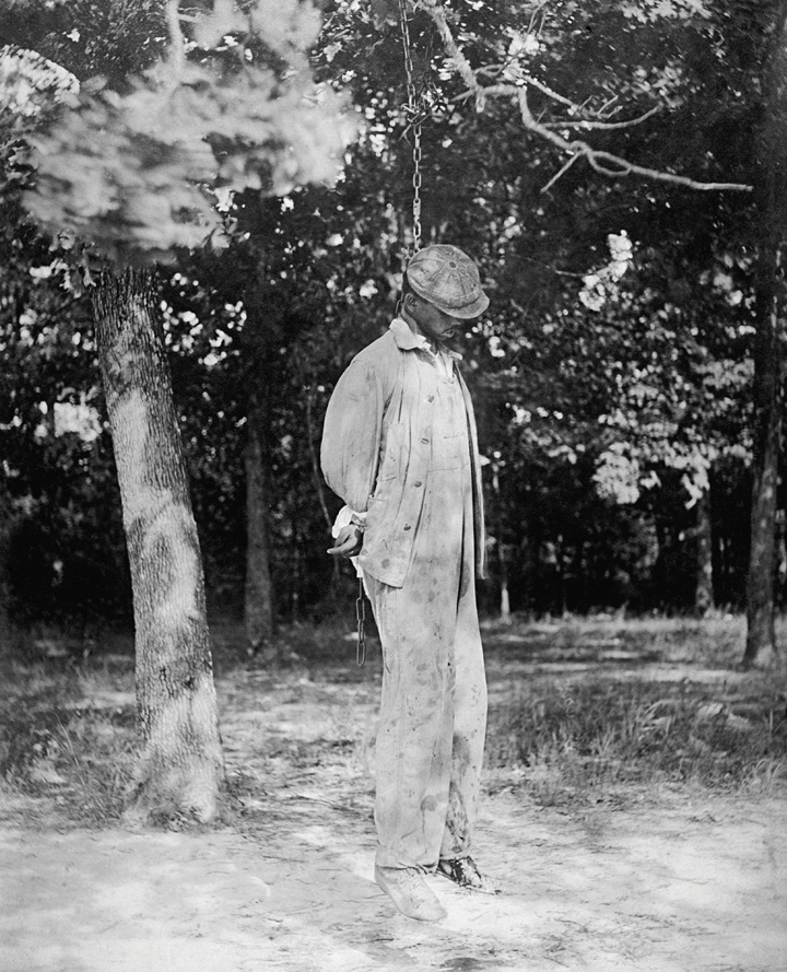 A picture of a lynched man hanging in a noose