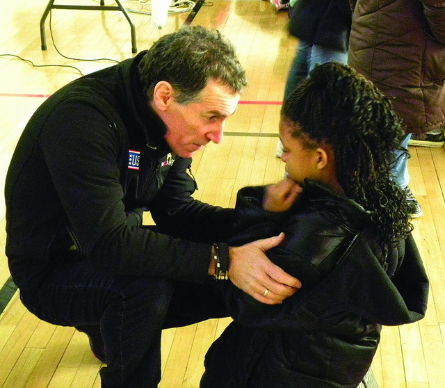 A police officer talking to a young girl