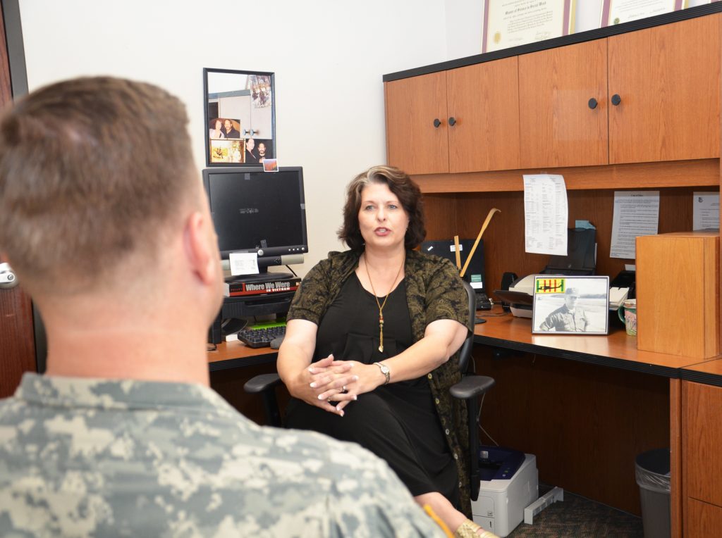 A woman social worker helping out a male veteran