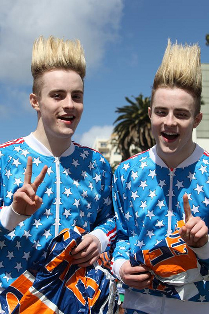 Two identical twins with spikey up blonde hair and American Flag jumpsuits