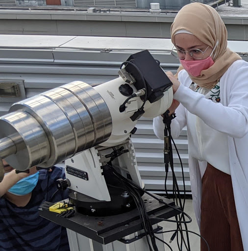 A student recalibrates the telescope.